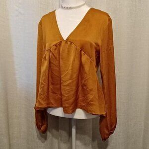 Orange blouse with a V Neck and satin finish